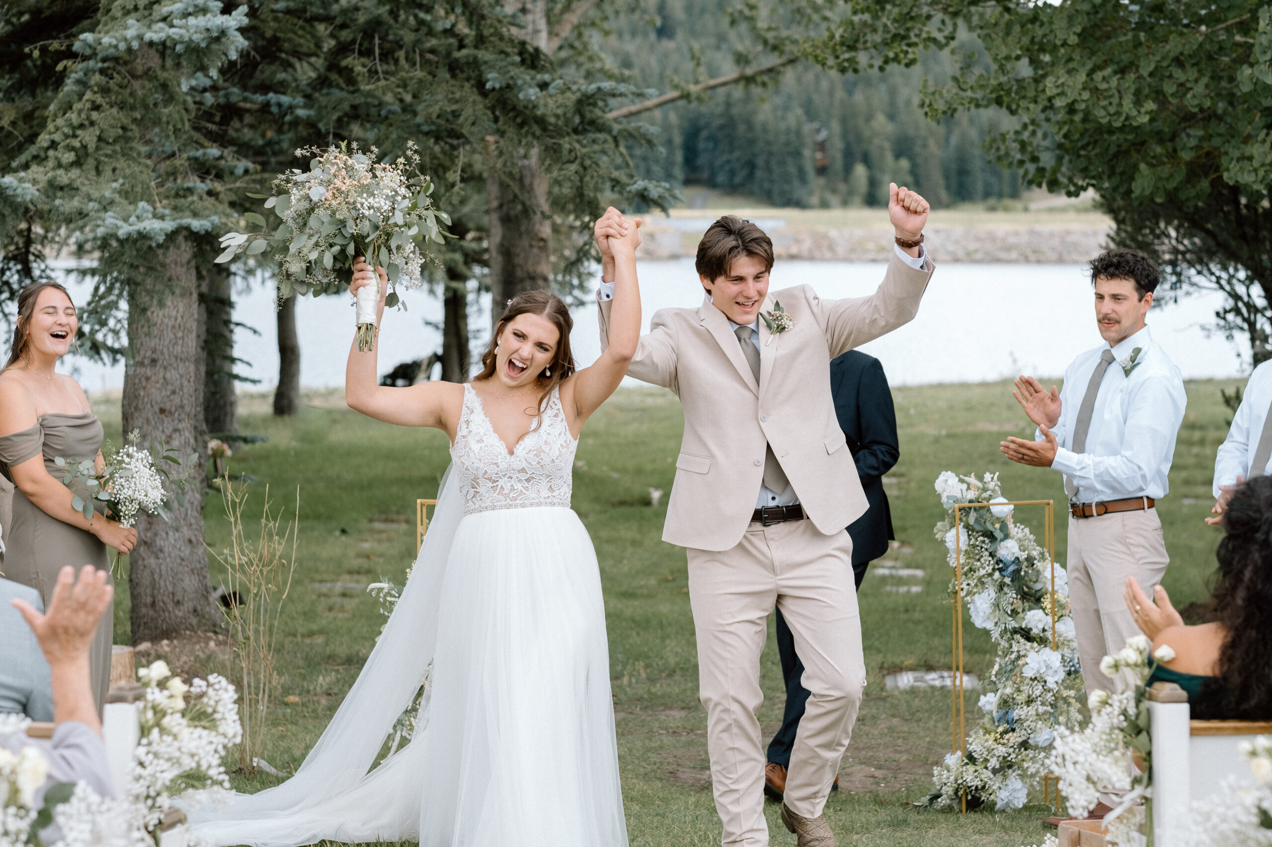 couple celebrates as they walk down the aisle colorado mountain wedding